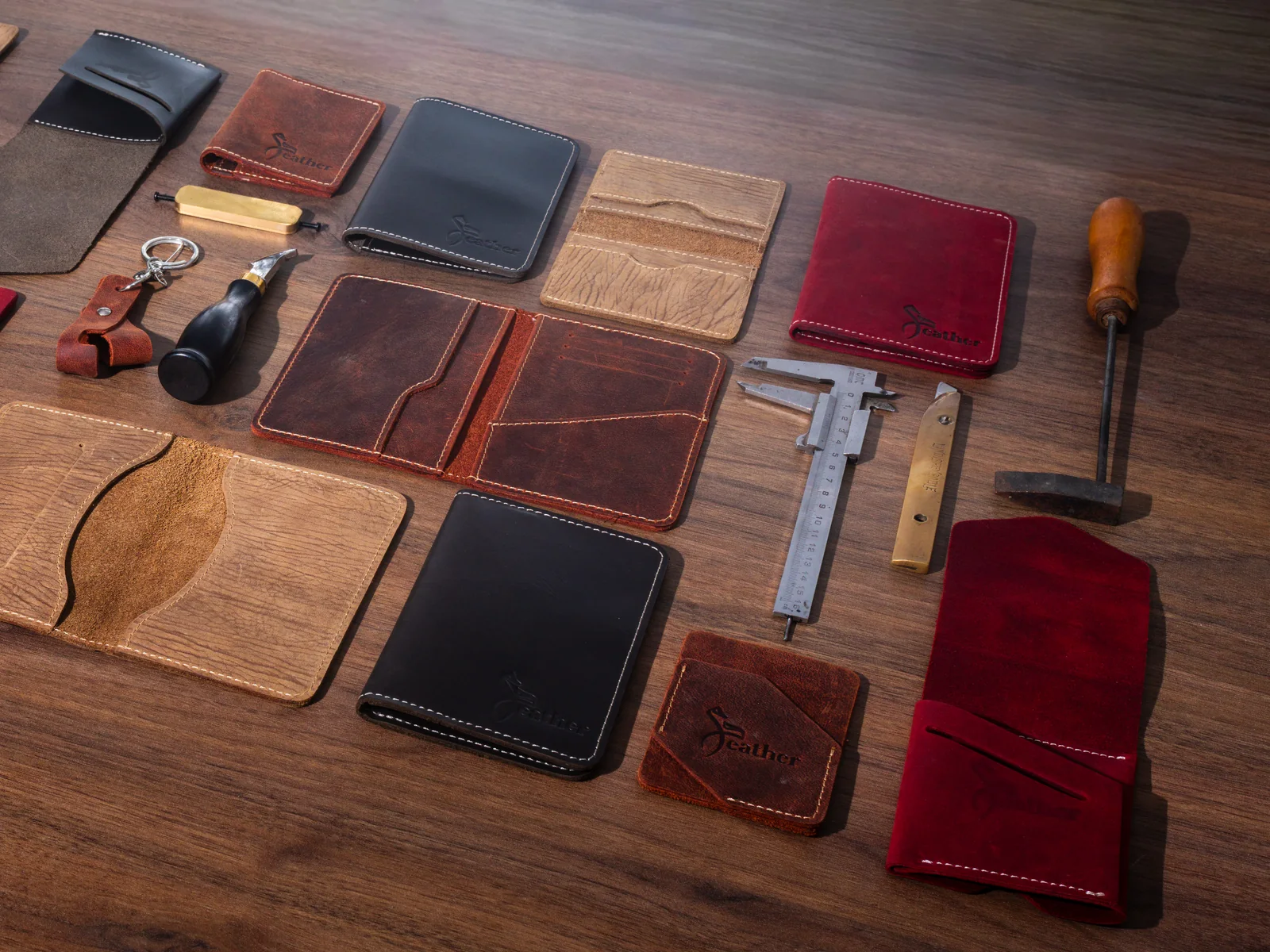 XEATHER leather collection arranged with atelier tools on a walnut workbench