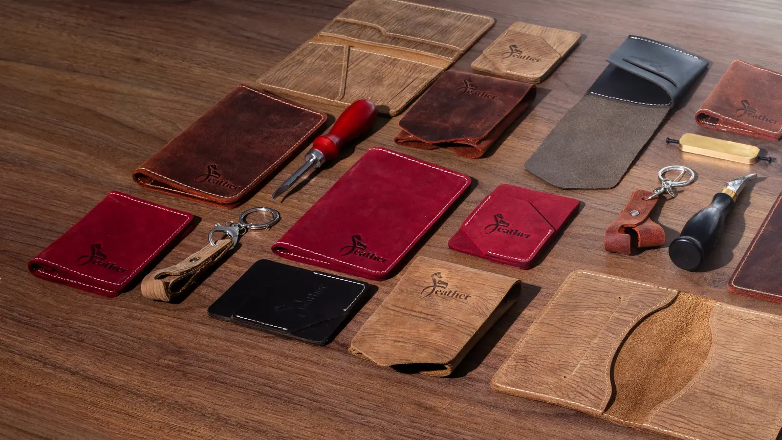 Handcrafted leather wallets and card holders gathered in warm workshop light